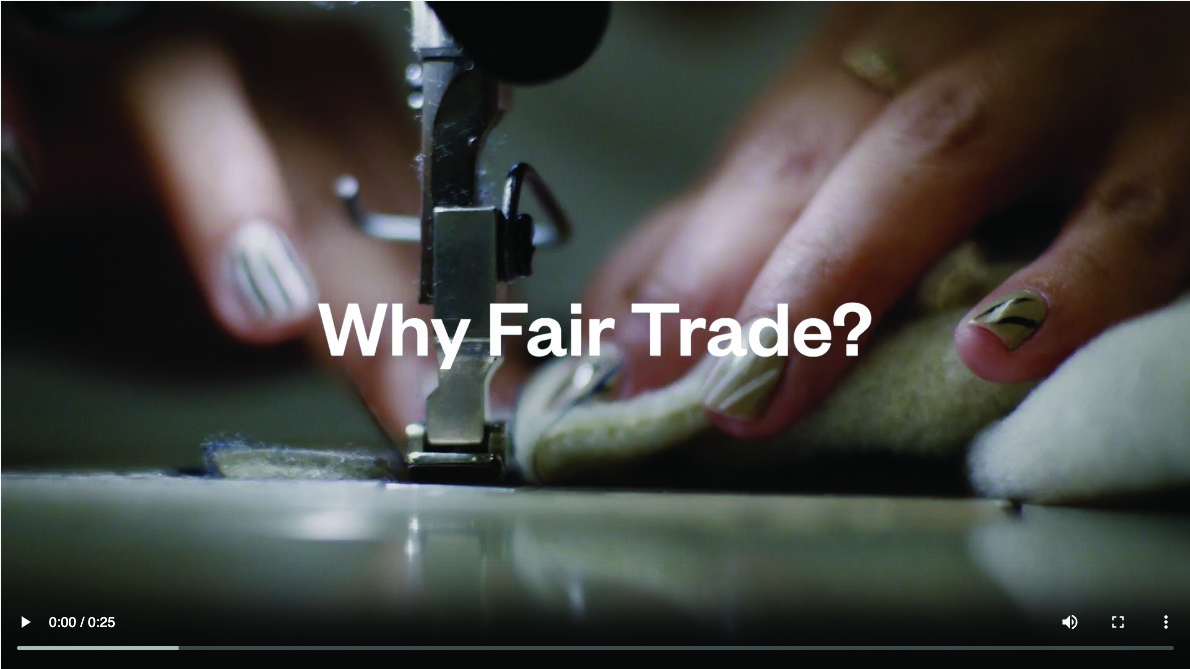 Still from the Fair Trade video ad. Text on top of a person sewing fabric on an industrial sewing machine reads "Why Fair Trade?"